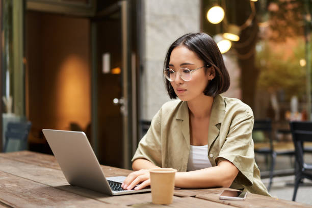 Language specialist working on a laptop in a café